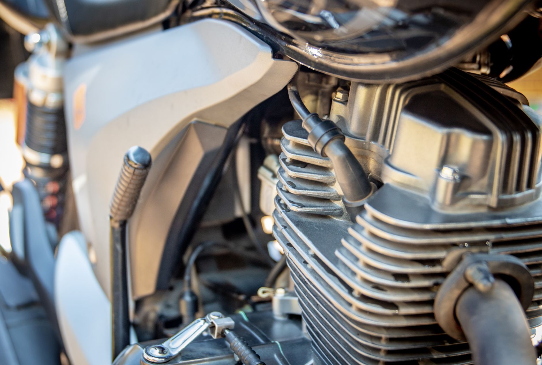 Detailed view of motorcycle engine, showcasing intricate mechanical parts. Ideal for automotive enthusiasts.