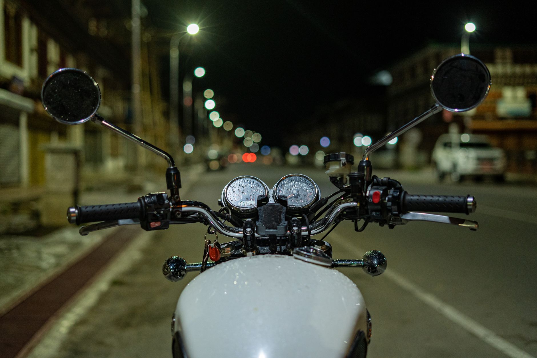 Front view of a motorcycle on a street in Paro, Bhutan, showcasing urban night life.