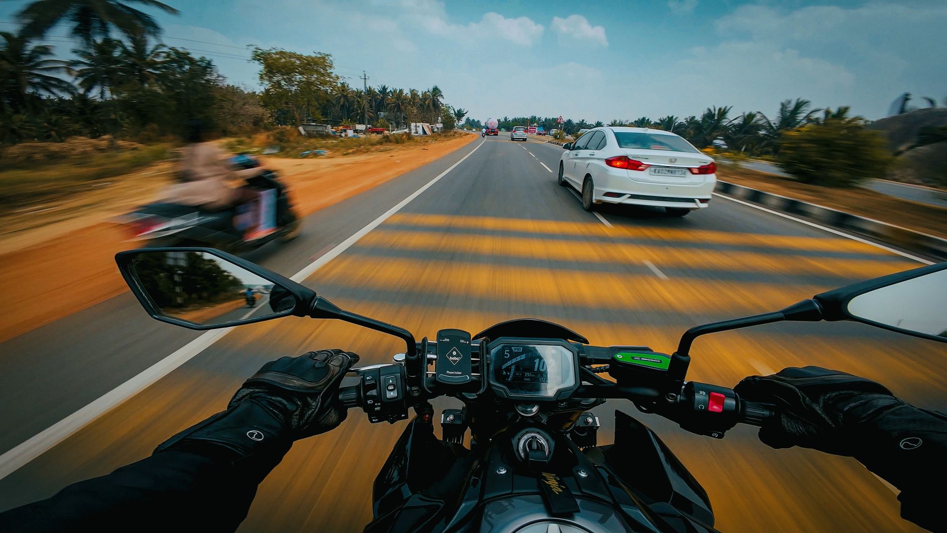 Dynamic POV view of a biker riding on a bustling Indian highway in Bengaluru.