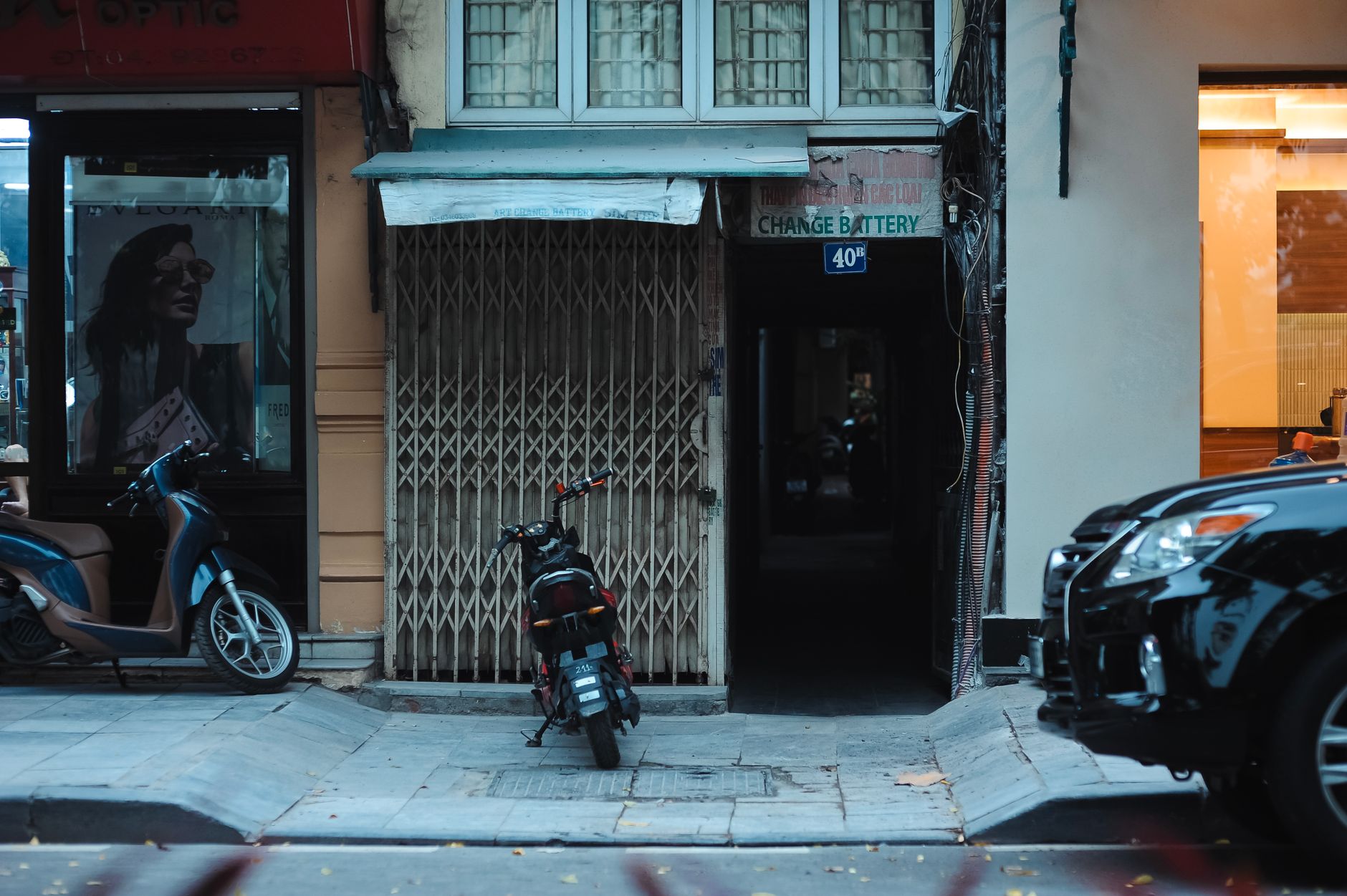 Street view with scooters, shop signs, and urban ambiance.