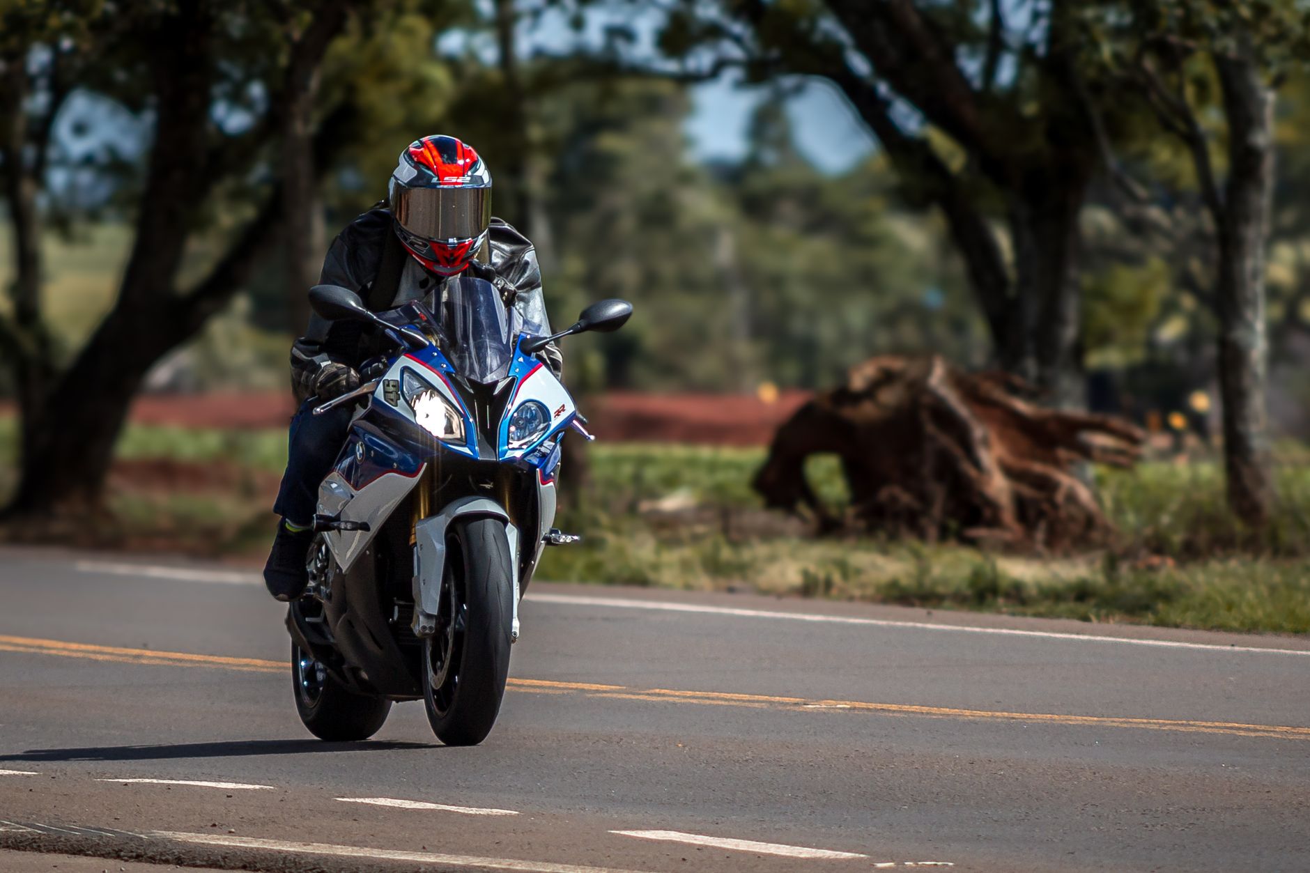 Motorcyclist racing on a road in Carazinho, highlighting speed and biker culture.